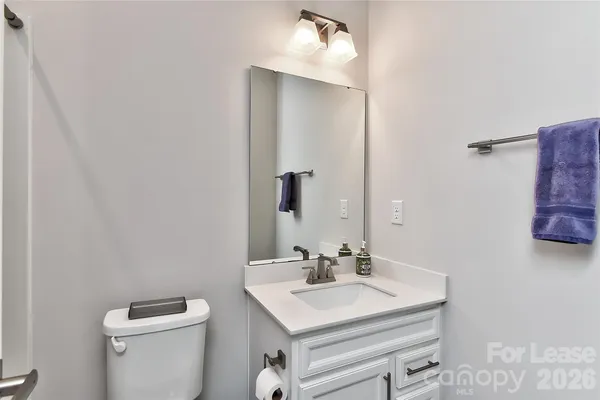 a bathroom with a sink toilet and mirror