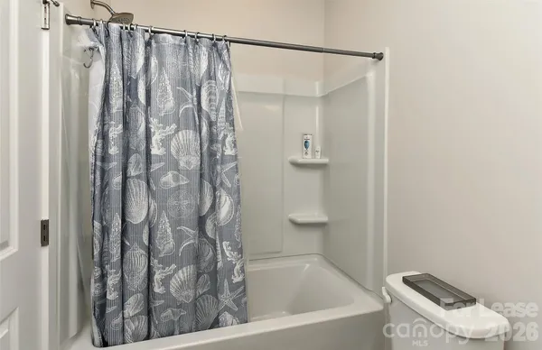 a bathroom with a shower curtain and a sink