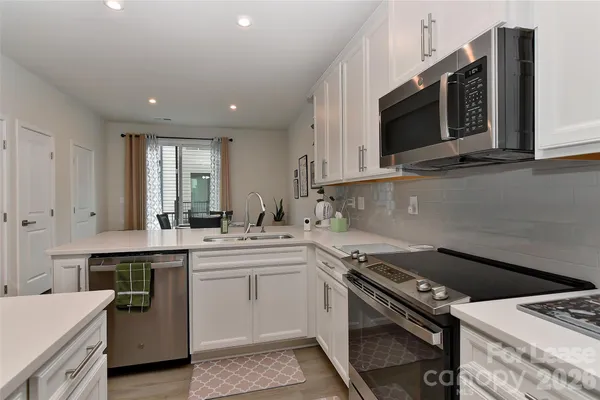 a kitchen with a stove and a microwave