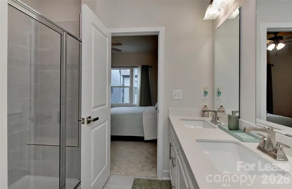 a bathroom with a tub sink and mirror