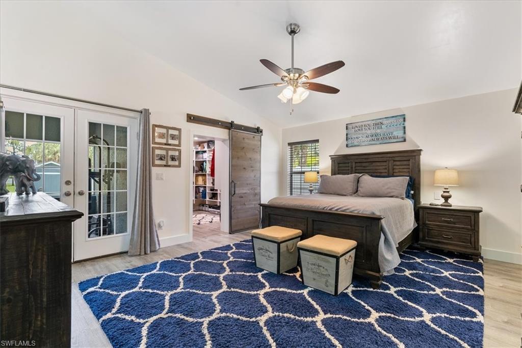 1820 19th Street Southwest Naples, FL 34117 - Photo 11 of 31 a bedroom with a bed and a chandelier