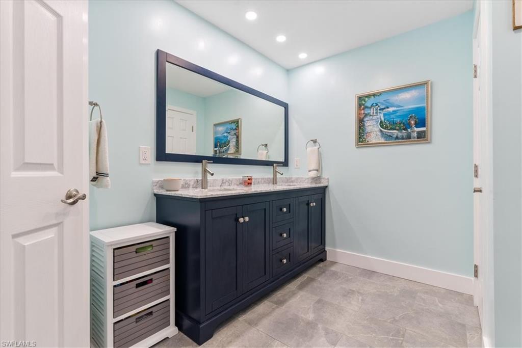 1820 19th Street Southwest Naples, FL 34117 - Photo 13 of 31 a bathroom with a double vanity sink and a mirror