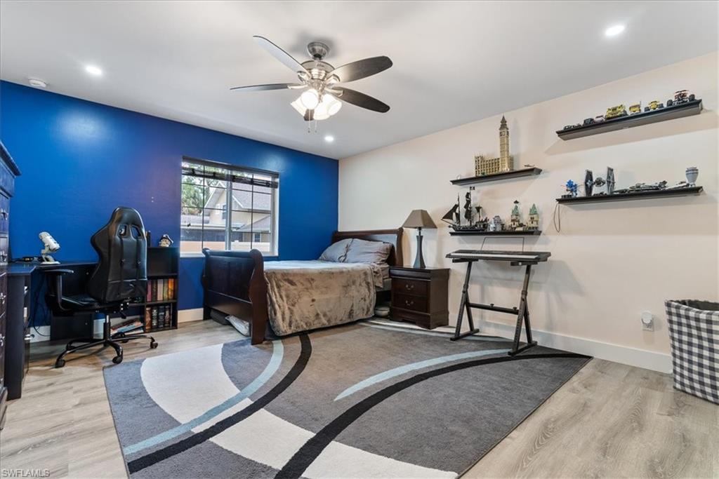 1820 19th Street Southwest Naples, FL 34117 - Photo 15 of 31 a bedroom with furniture and a chandelier