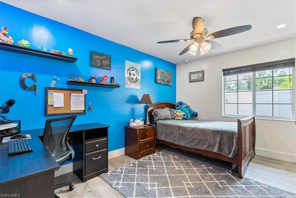 1820 19th Street Southwest Naples, FL 34117 - Photo 17 of 31 a bedroom with furniture and a chandelier