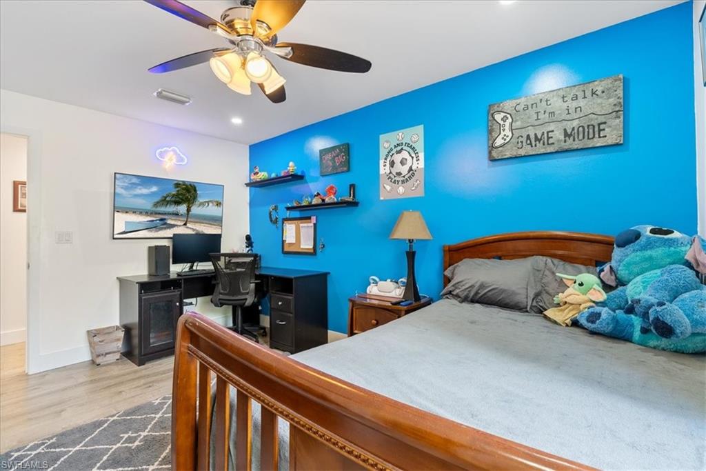 1820 19th Street Southwest Naples, FL 34117 - Photo 18 of 31 a bedroom with bed and a chandelier