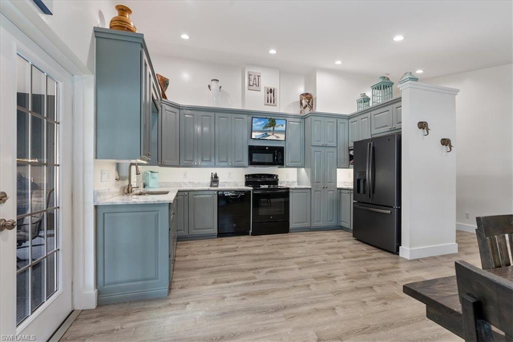 1820 19th Street Southwest Naples, FL 34117 - Photo 2 of 31 a large kitchen with stainless steel appliances kitchen island granite countertop a refrigerator and a sink