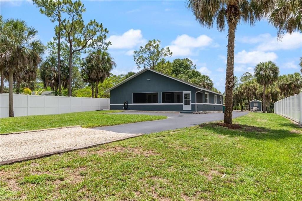 1820 19th Street Southwest Naples, FL 34117 - Photo 24 of 31 a front view of house with yard and green space