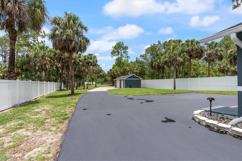 1820 19th Street Southwest Naples, FL 34117 - Photo 28 of 31 a view of a tennis ground with large trees