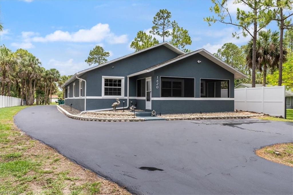 1820 19th Street Southwest Naples, FL 34117 - Photo 29 of 31 a front view of a house with a yard and garage