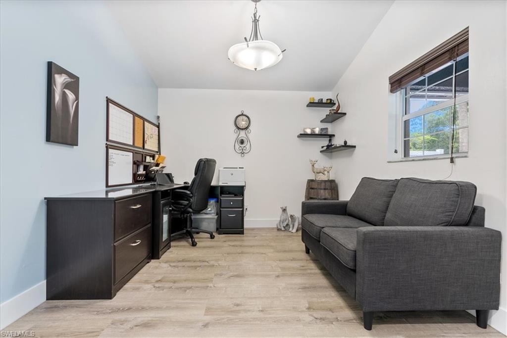 1820 19th Street Southwest Naples, FL 34117 - Photo 7 of 31 a living room with furniture and a flat screen tv