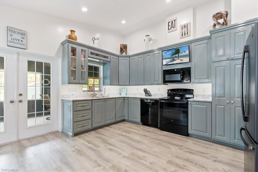 1820 19th Street Southwest Naples, FL 34117 - Photo 8 of 31 a kitchen with granite countertop a refrigerator stove top oven and sink