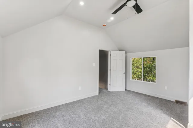 a view of a livingroom with a ceiling fan and window