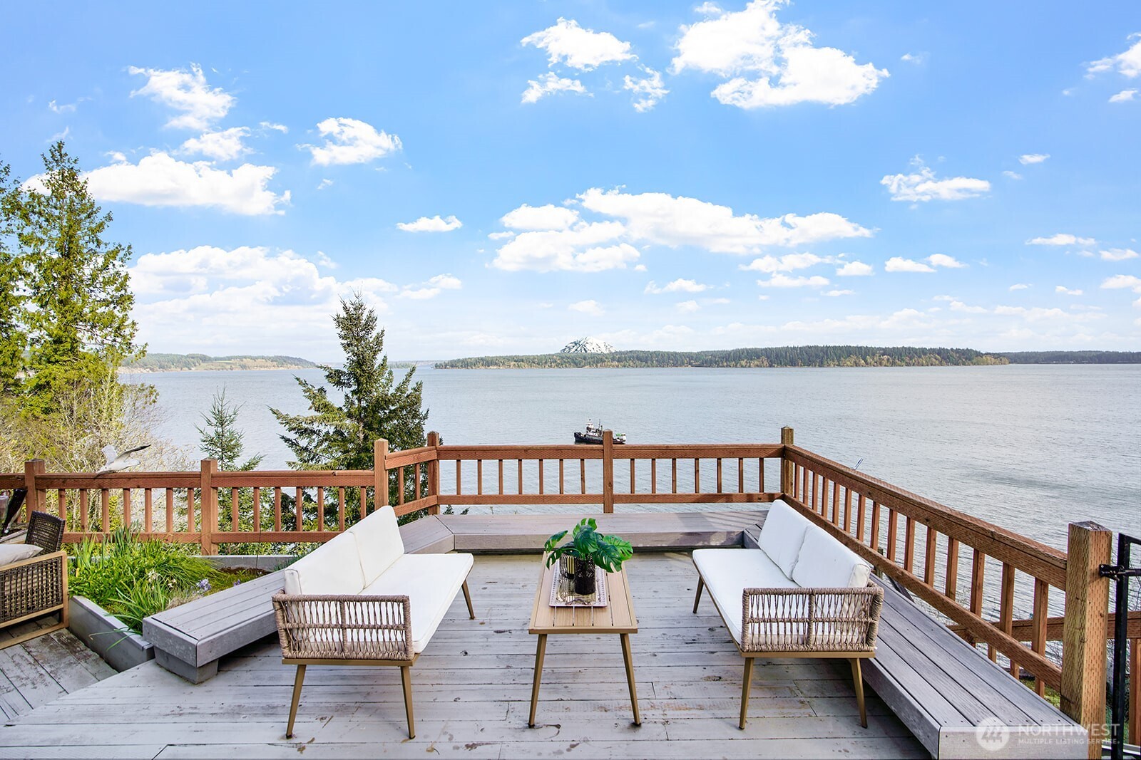 a view of a chairs and table on the roof deck