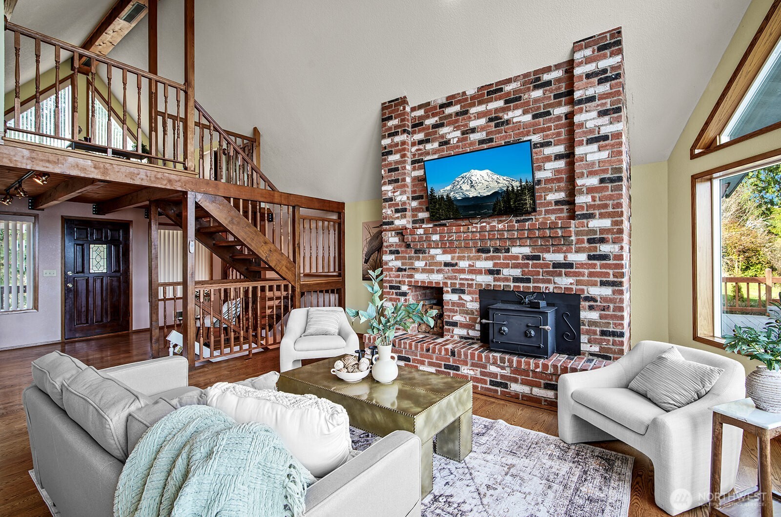 6819 Clf Avenue Southwest Longbranch, WA 98351 - Photo 11 of 29 a living room with furniture a flat screen tv and a fireplace
