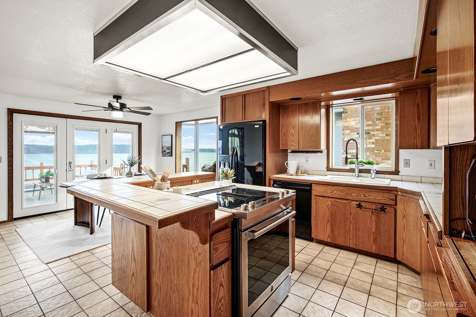 6819 Clf Avenue Southwest Longbranch, WA 98351 - Photo 13 of 29 a kitchen with a stove a sink dishwasher and a refrigerator