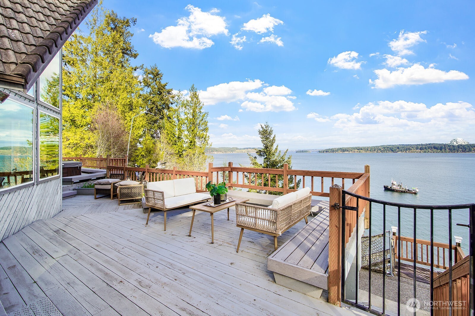 6819 Clf Avenue Southwest Longbranch, WA 98351 - Photo 5 of 29 a balcony view with couple of chairs and wooden floor