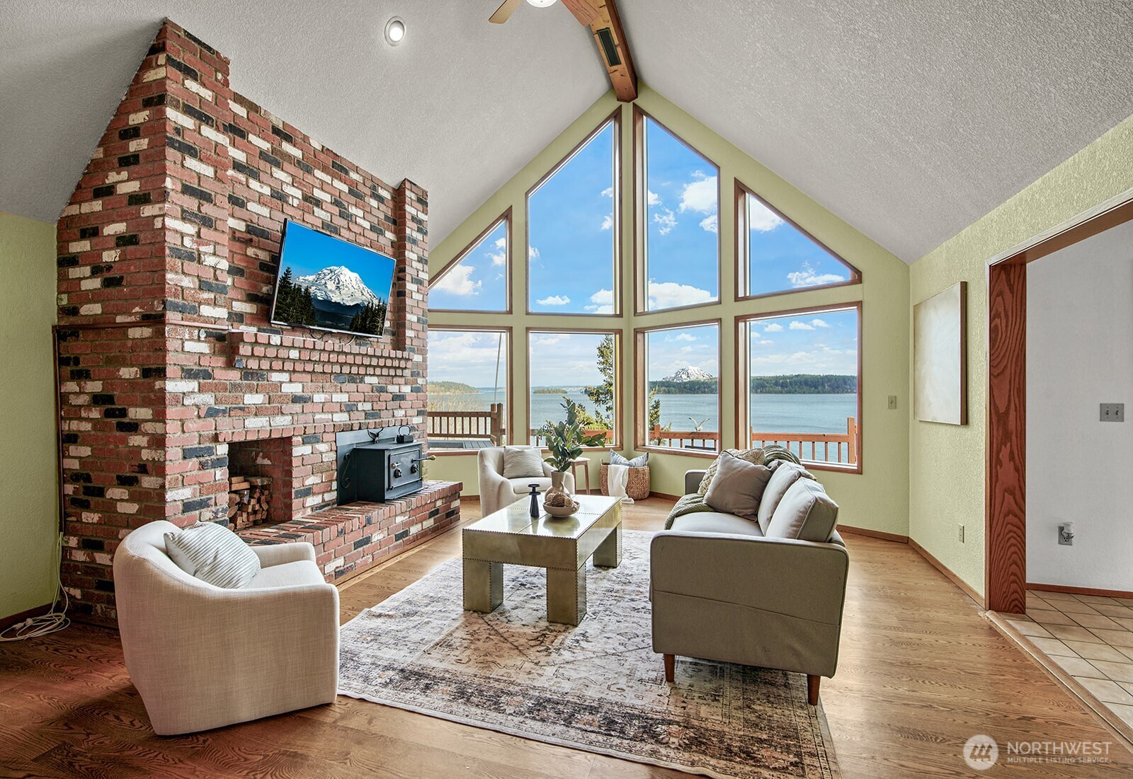 6819 Clf Avenue Southwest Longbranch, WA 98351 - Photo 7 of 29 a living room with fireplace furniture and a floor to ceiling window