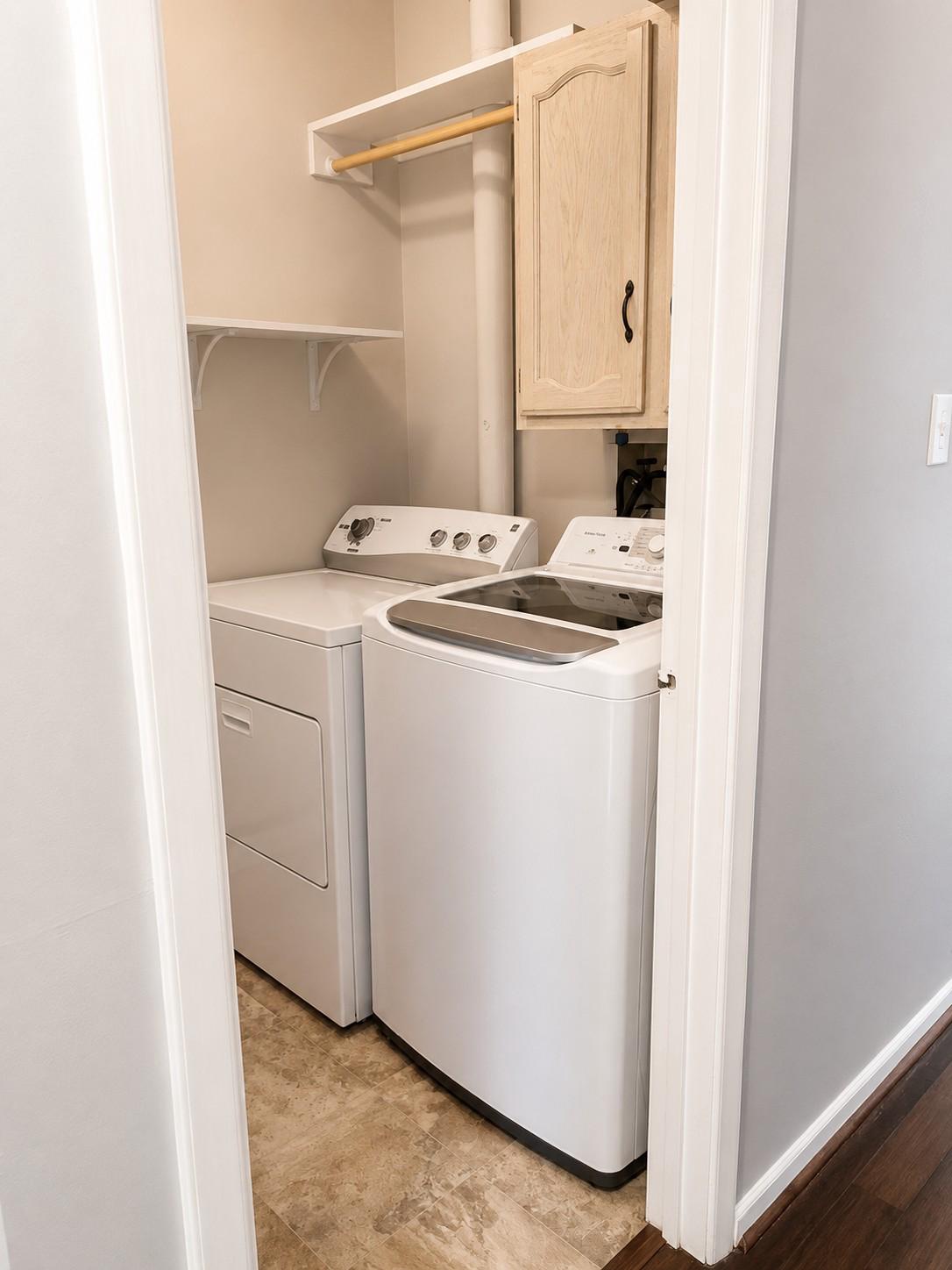 7006 Basswood Road Frederick, MD 21703 - Photo 7 of 10 a view of a storage and utility room with washer and dryer