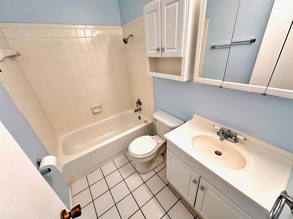 2215 Post Road, Unit 1010 Austin, TX 78704 - Photo 12 of 25 a bathroom with a sink a toilet and shower
