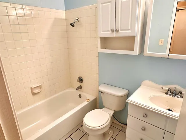 a bedroom with a bed and a flat tv screen