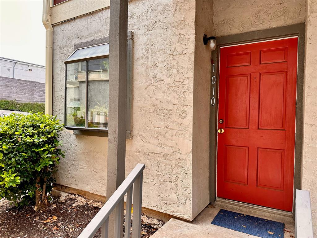 2215 Post Road, Unit 1010 Austin, TX 78704 - Photo 2 of 25 wooden floor with red door