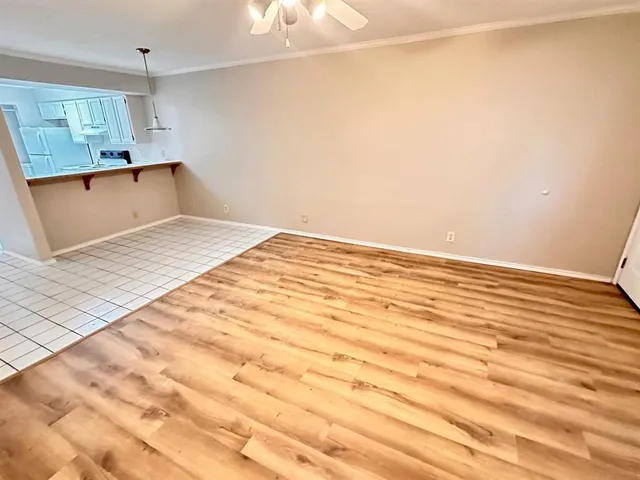 a view of a room with wooden floor and cabinet
