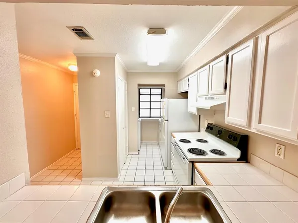 a kitchen with a window a sink and a cabinets
