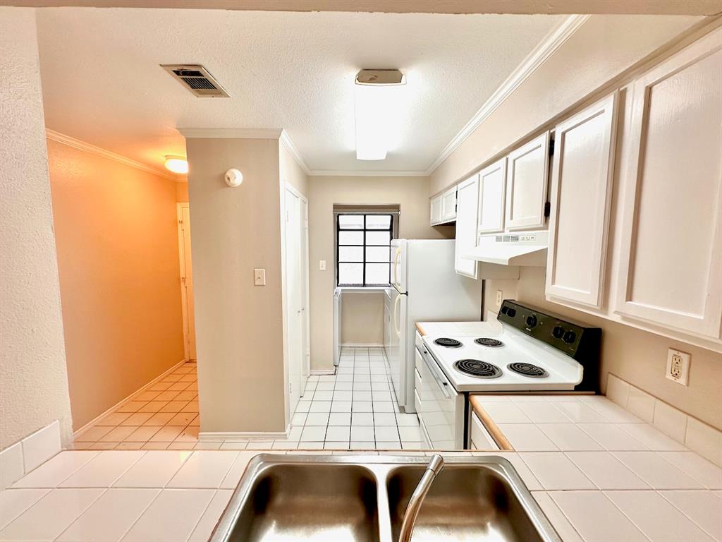 2215 Post Road, Unit 1010 Austin, TX 78704 - Photo 6 of 25 a kitchen with a window a sink and a cabinets