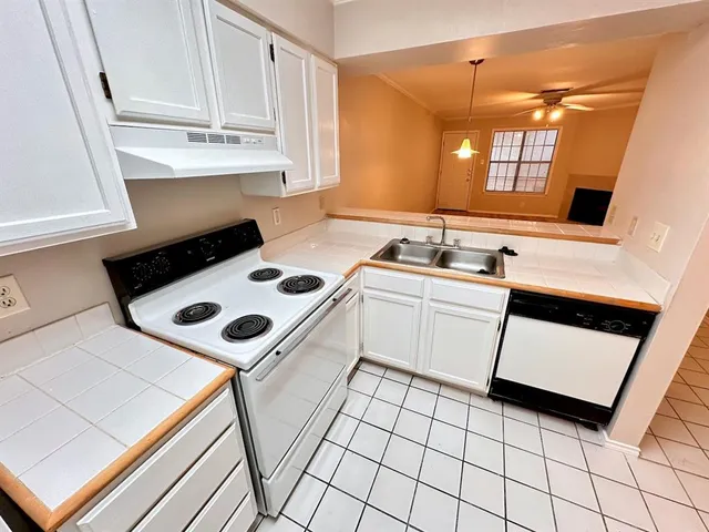 a utility room with sink dryer and washer