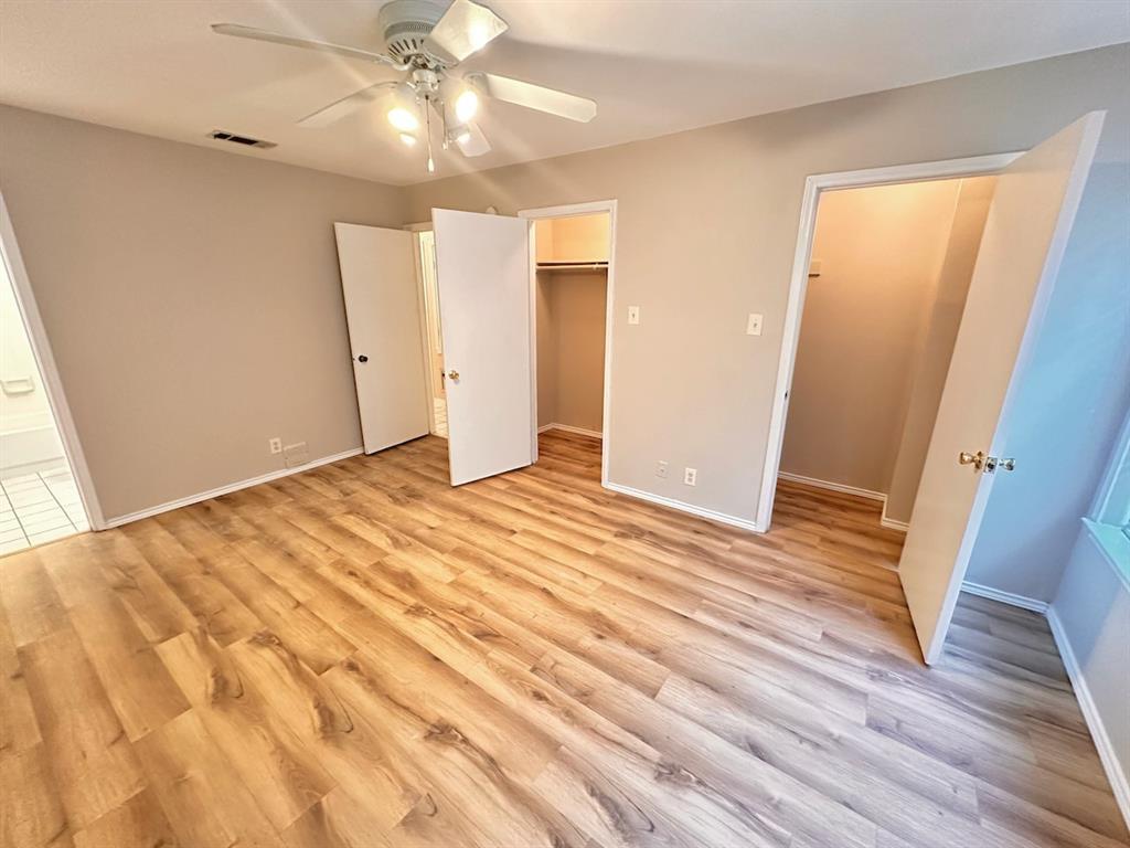 2215 Post Road, Unit 1010 Austin, TX 78704 - Photo 10 of 25 a view of an empty room with wooden floor and a window