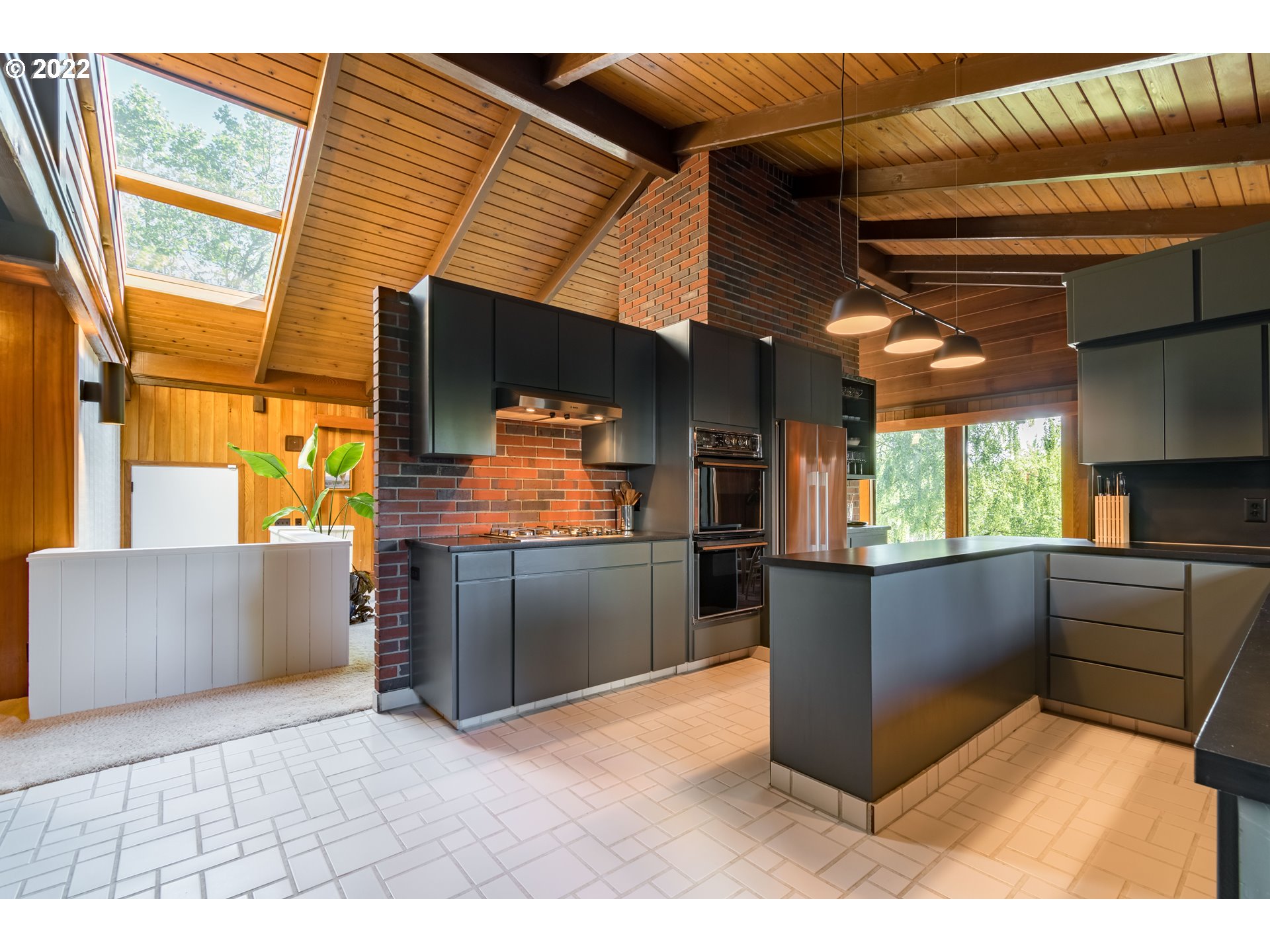 2000 University Street Eugene, OR 97403 - Photo 8 of 32 a kitchen with stainless steel appliances kitchen island granite countertop a refrigerator and a stove top oven