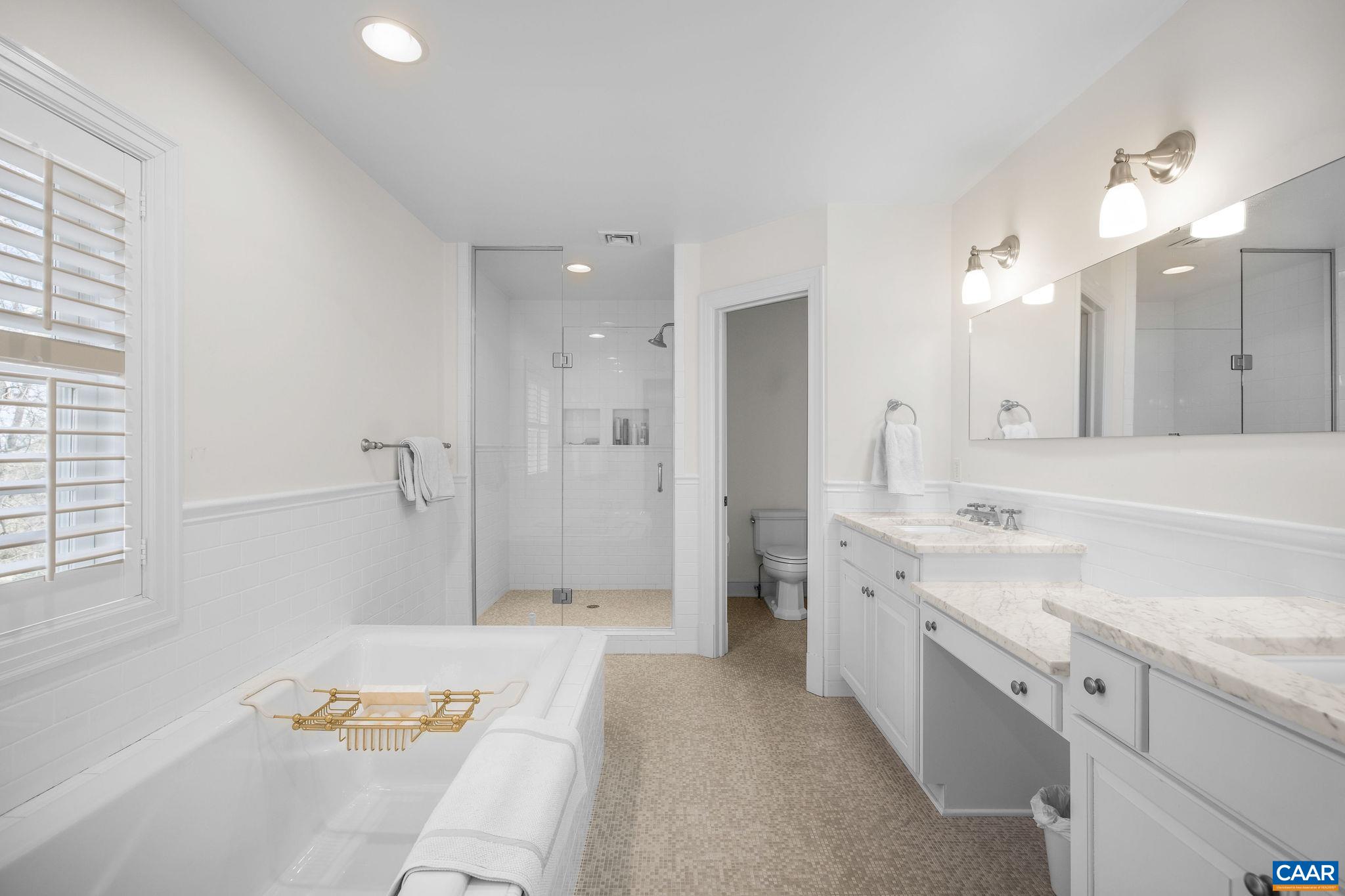 2418 Northfield Road Charlottesville, VA 22901 - Photo 23 of 47 a spacious bathroom with a sink a mirror a shower and a bathtub