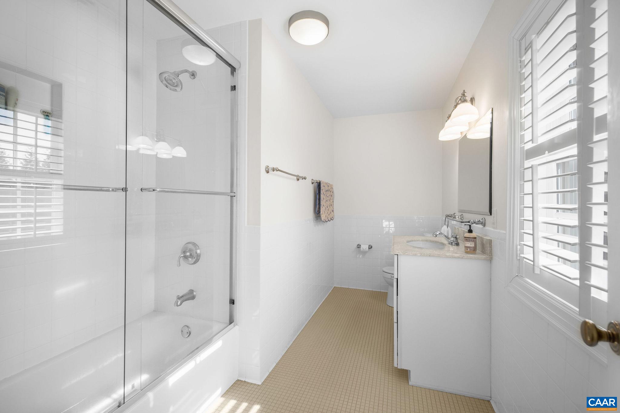 2418 Northfield Road Charlottesville, VA 22901 - Photo 29 of 47 a bathroom with a tub sink and mirror