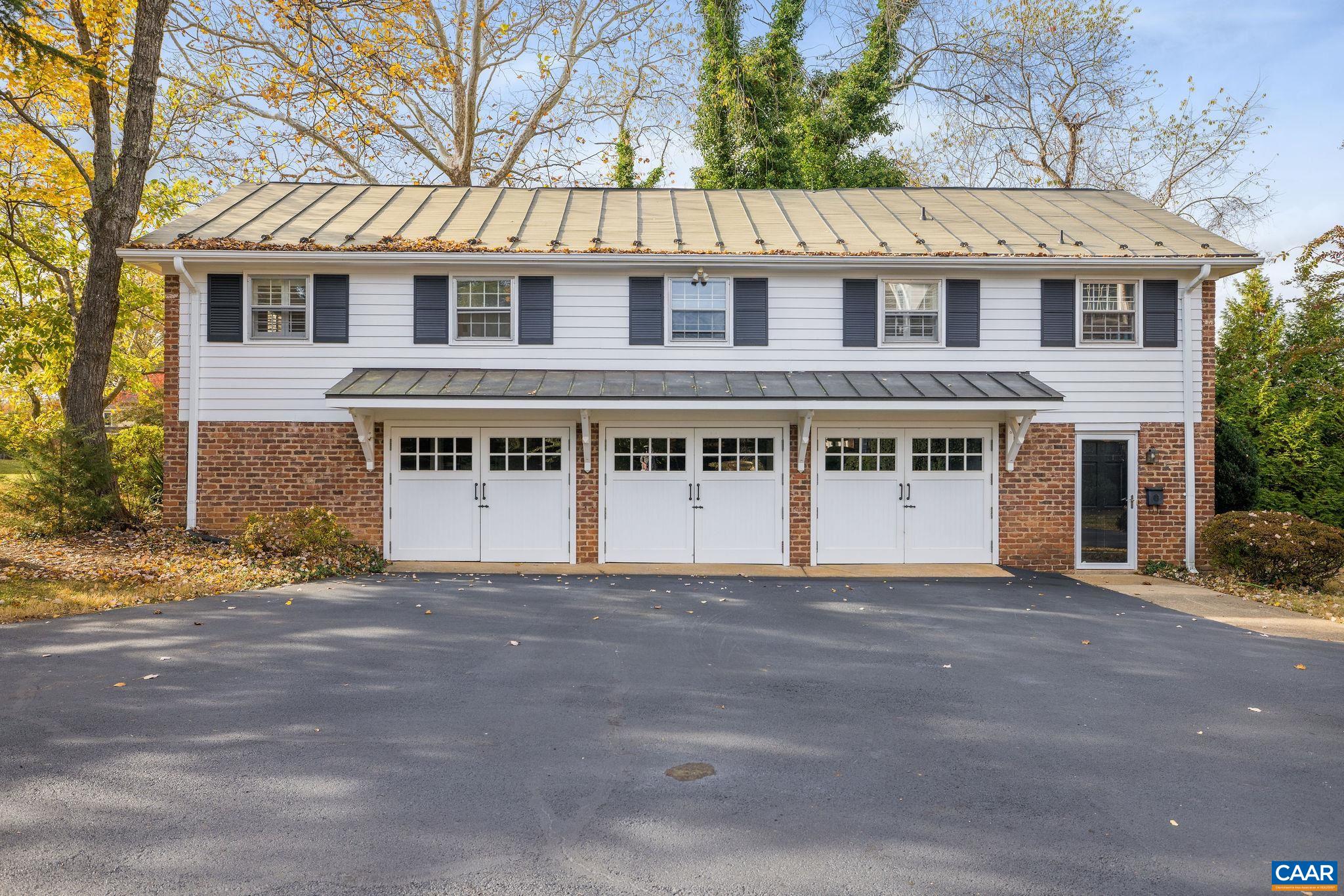 2418 Northfield Road Charlottesville, VA 22901 - Photo 3 of 47 a view of a white house with a large windows and a large tree