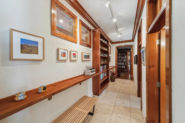 a hallway with a large refrigerator and a stove