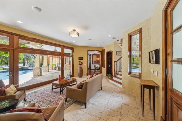 a living room with furniture and large windows