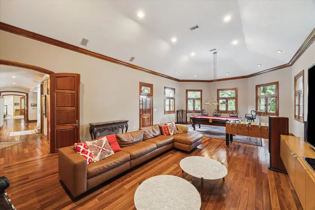 a living room with furniture and wooden floor
