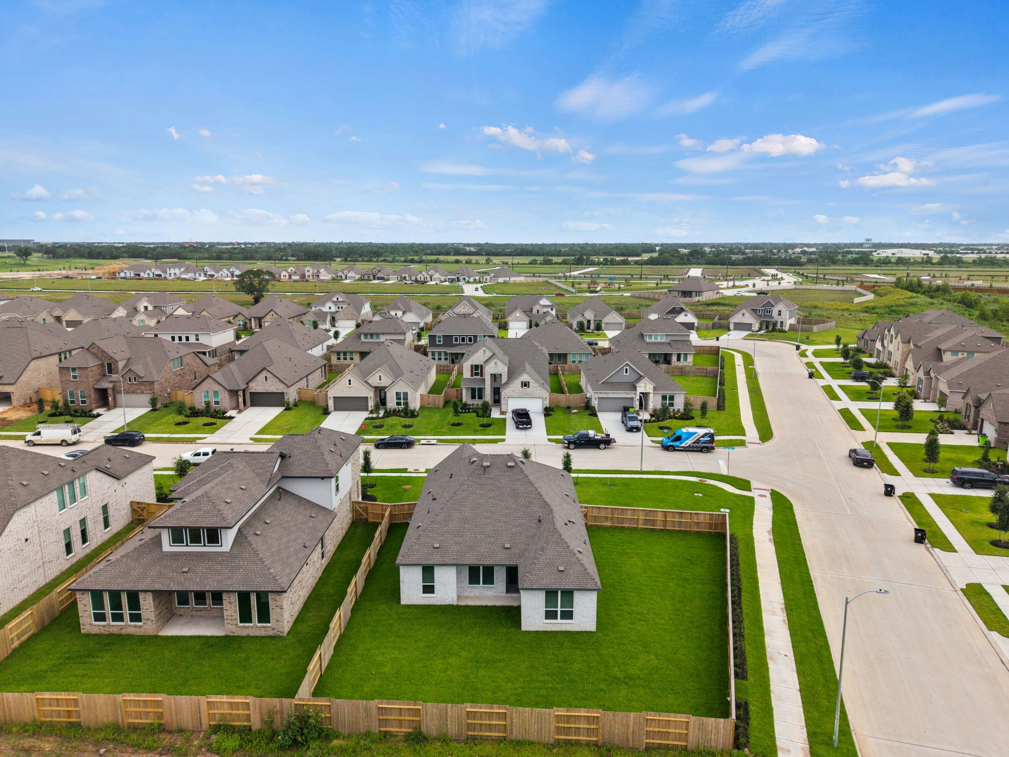 2720 Grove Crest Drive Rosenberg, TX 77469 - Photo 5 of 32 Bird’s-eye view showcasing the spacious fenced backyard, neighboring homes, and the thoughtfully designed community surroundings.