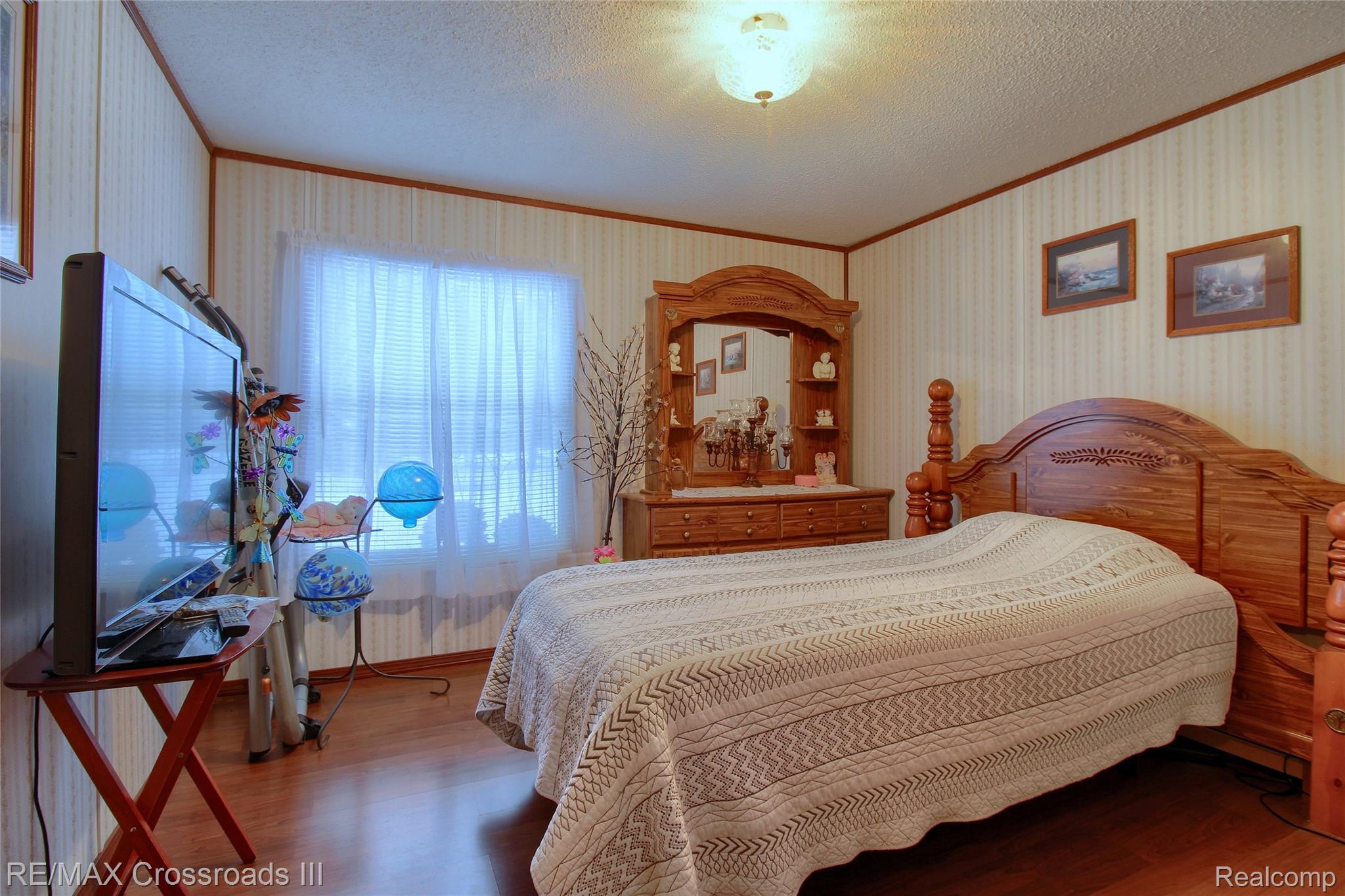 48620 Wear Road Belleville, MI 48111 - Photo 18 of 24 Bedroom with wood finished floors, wallpapered walls, a textured ceiling, and crown molding