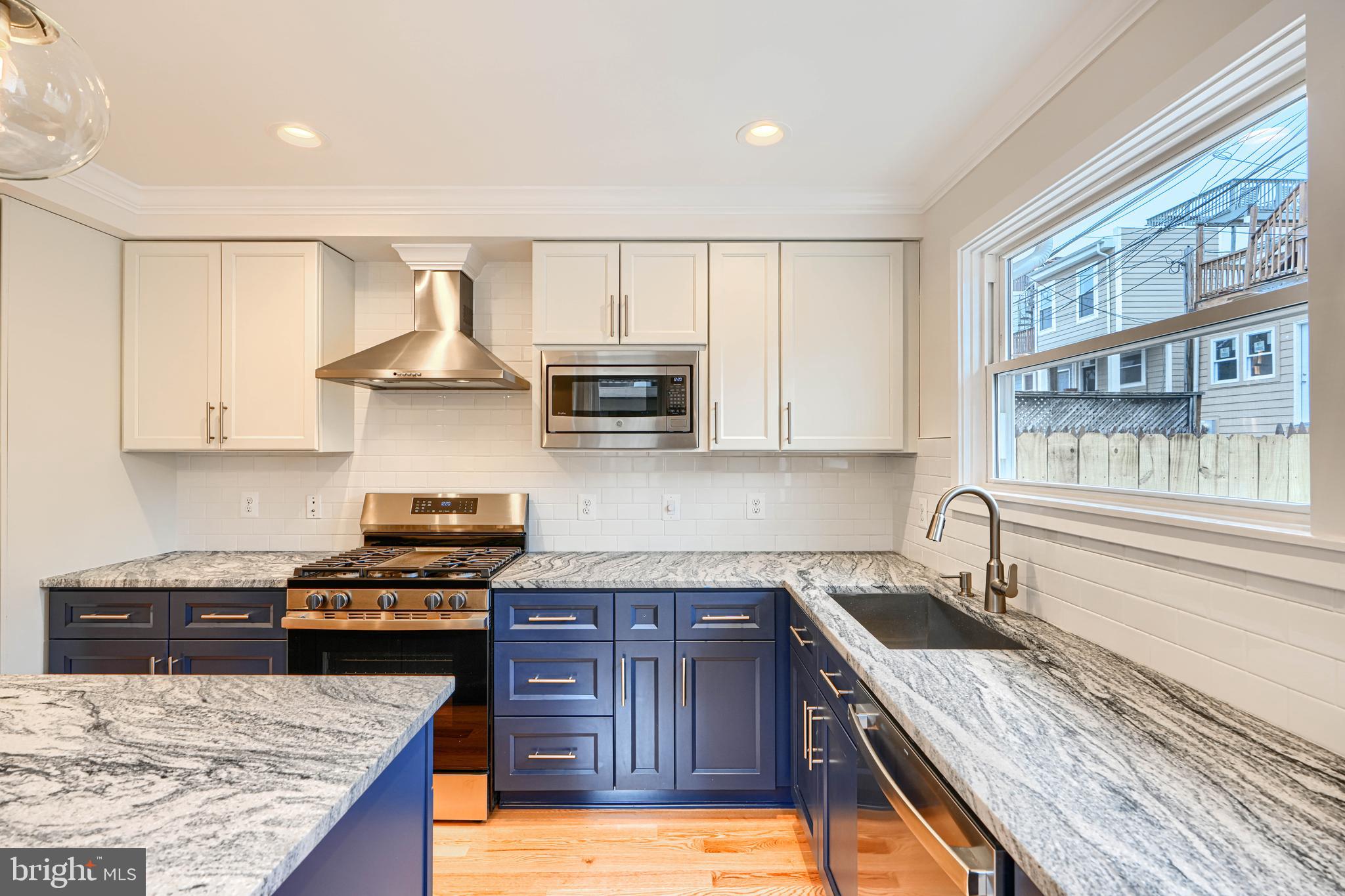 719 South Robinson Street Baltimore, MD 21224 - Photo 11 of 31 a kitchen with granite countertop a stove sink and cabinets