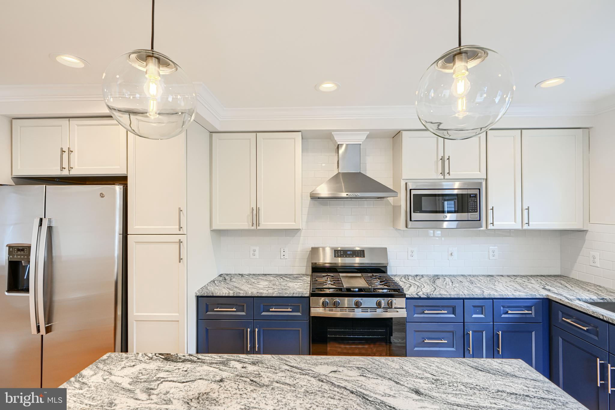 719 South Robinson Street Baltimore, MD 21224 - Photo 12 of 31 a kitchen with stainless steel appliances a stove a refrigerator and cabinets