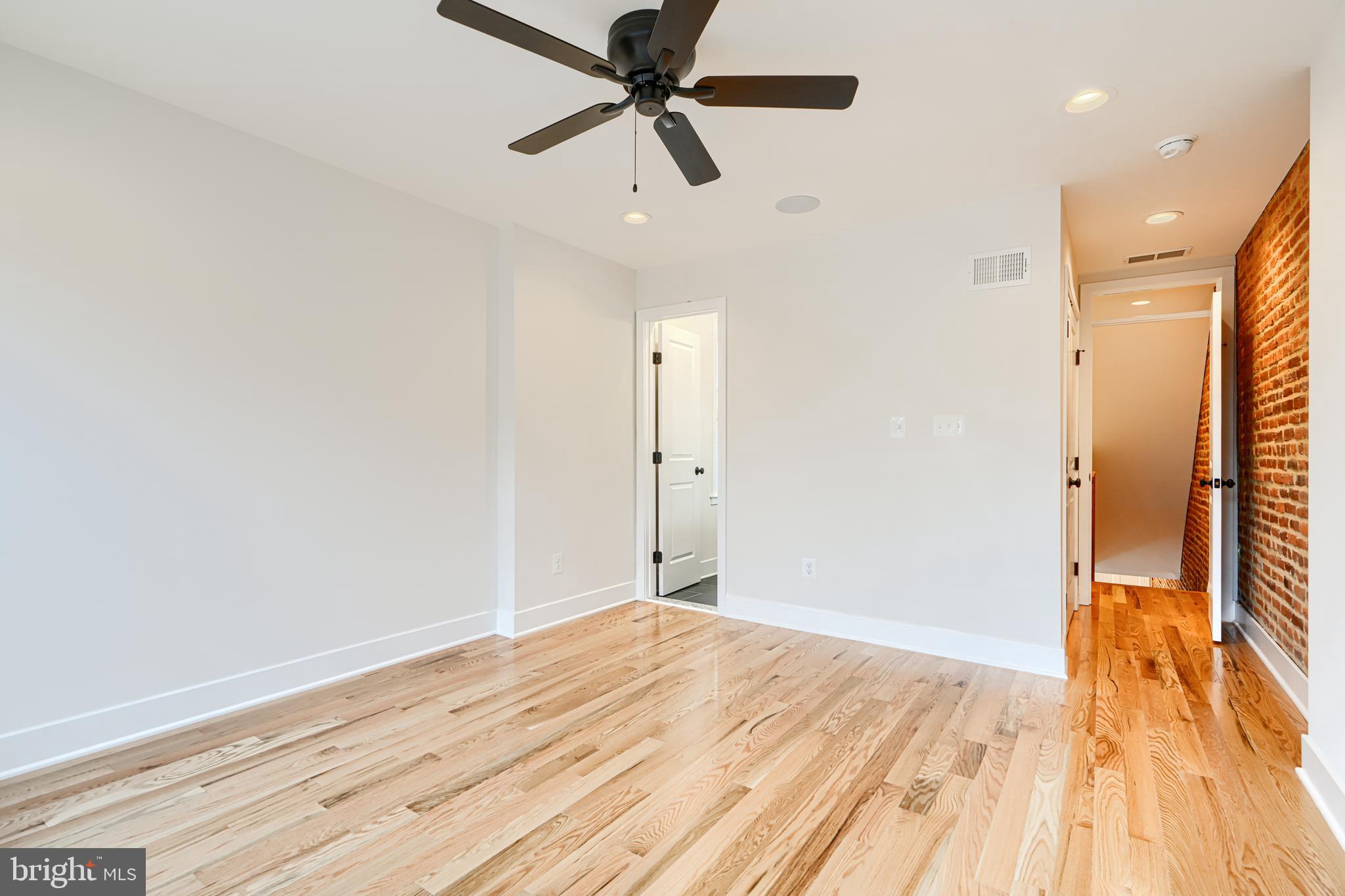 719 South Robinson Street Baltimore, MD 21224 - Photo 24 of 31 a view of a room with wooden floor and a ceiling fan
