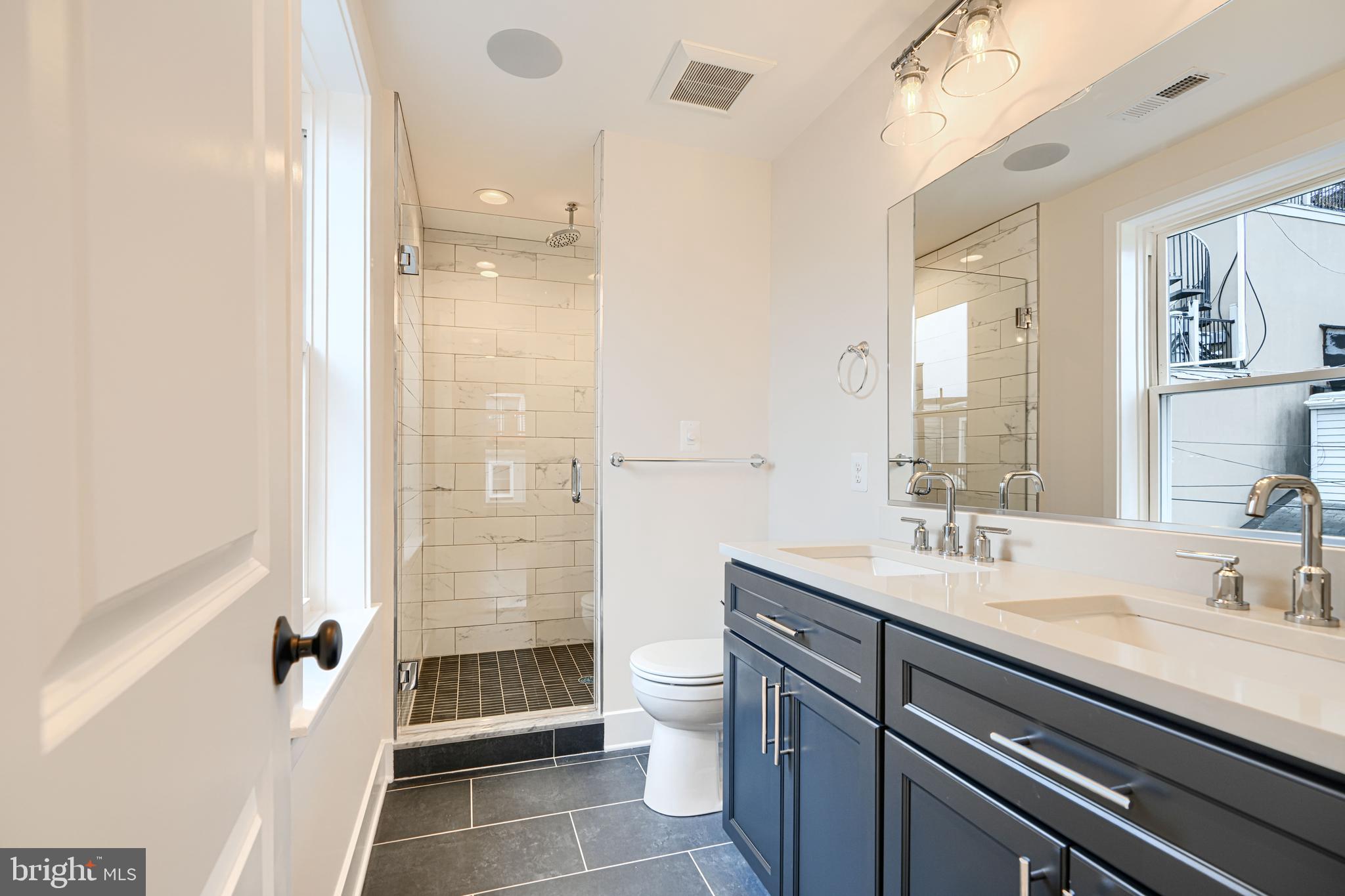 719 South Robinson Street Baltimore, MD 21224 - Photo 27 of 31 a bathroom with a sink a toilet a shower and a mirror
