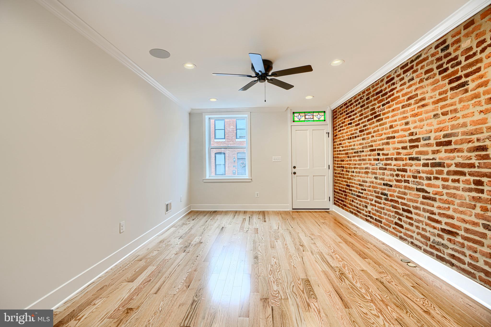 719 South Robinson Street Baltimore, MD 21224 - Photo 6 of 31 a view of empty room with wooden floor and fan