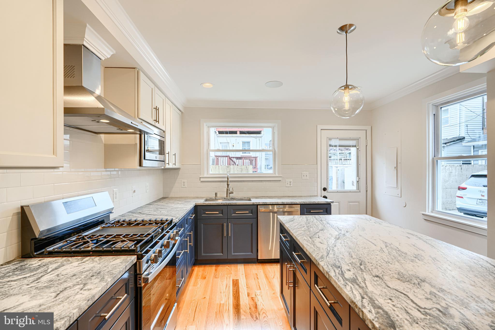719 South Robinson Street Baltimore, MD 21224 - Photo 10 of 31 a kitchen with stainless steel appliances granite countertop a stove a sink and a refrigerator