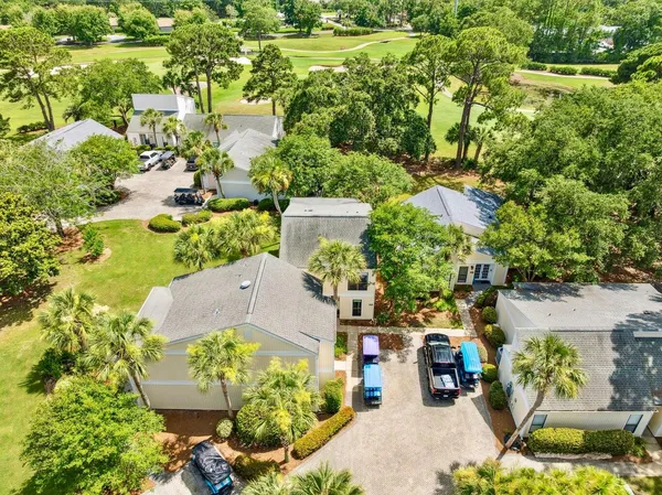 an aerial view of residential houses with outdoor space and street view