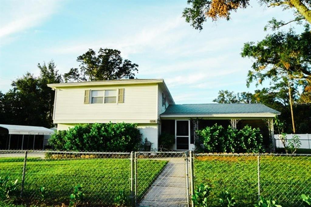1218 Hummingbird Lane Brandon, FL 33511 - Photo 1 of 1 a view of a house with backyard and a garden