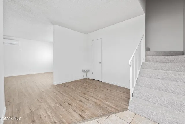 a view of an empty room with stairs