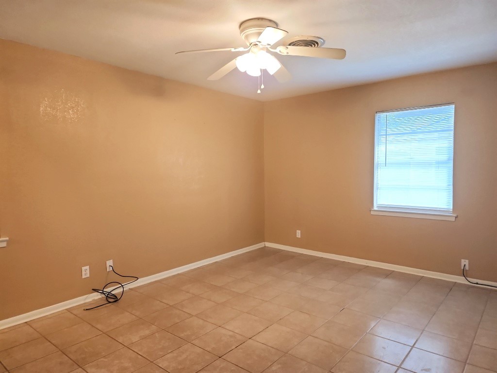 807 Country Club Road Georgetown, TX 78628 - Photo 21 of 31 Unfurnished room with ceiling fan and light tile patterned flooring
