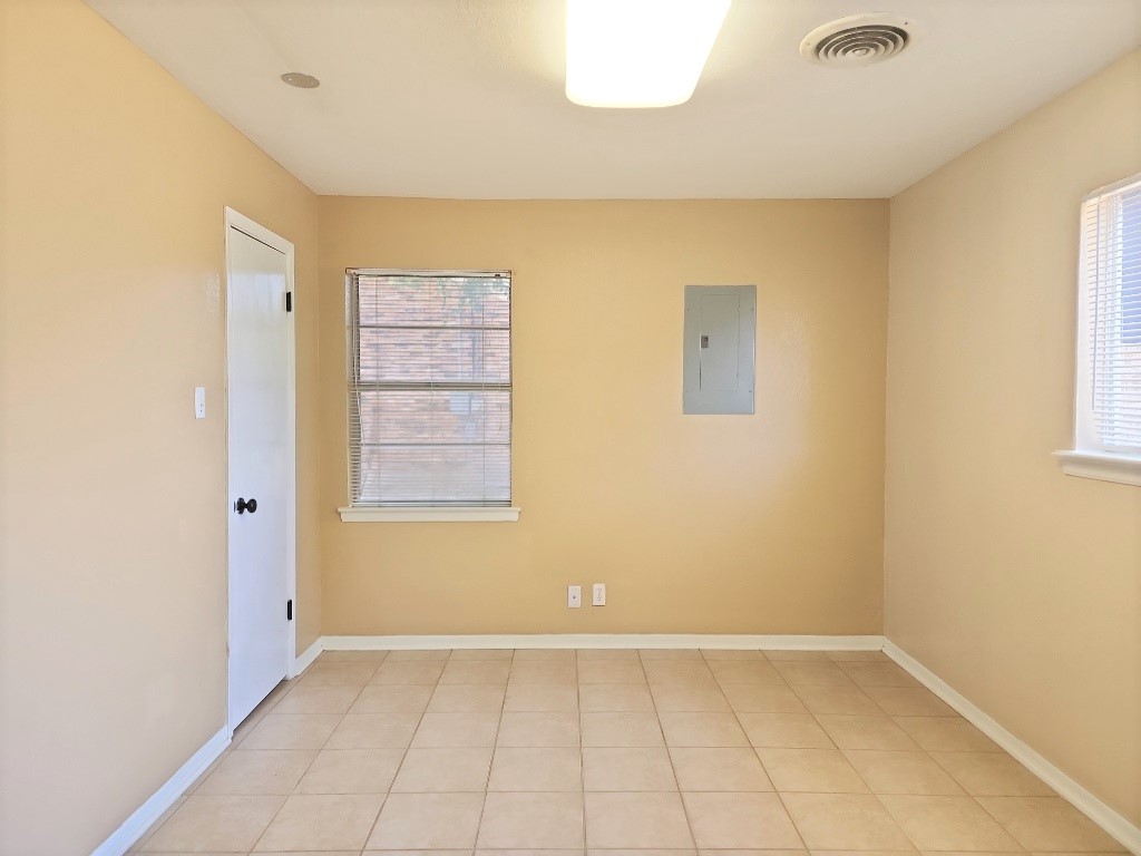 807 Country Club Road Georgetown, TX 78628 - Photo 28 of 31 Spare room with light tile patterned floors and electric panel